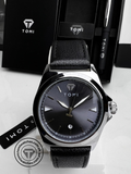 TOMI T-041 black dial watch with black leather strap and silver case on display