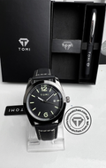Minimalist black leather watch with olive numeral markers and TOMI pen