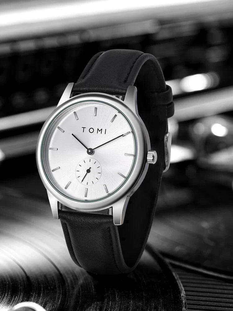 TOMI T-088 Business Quartz Unisex Watch – Silver-cased watch with a white dial displayed on a circular, textured surface.
