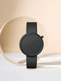 TOMI T-078 Unisex Watch Leather Strap - All-black minimalist watch standing upright against a light background.