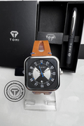 Black dial TOMI T-094 watch with blue accents and tan leather strap displayed on a stand
