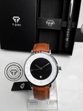 White dial TOMI T-085 men's watch with tan leather strap and silver case on display