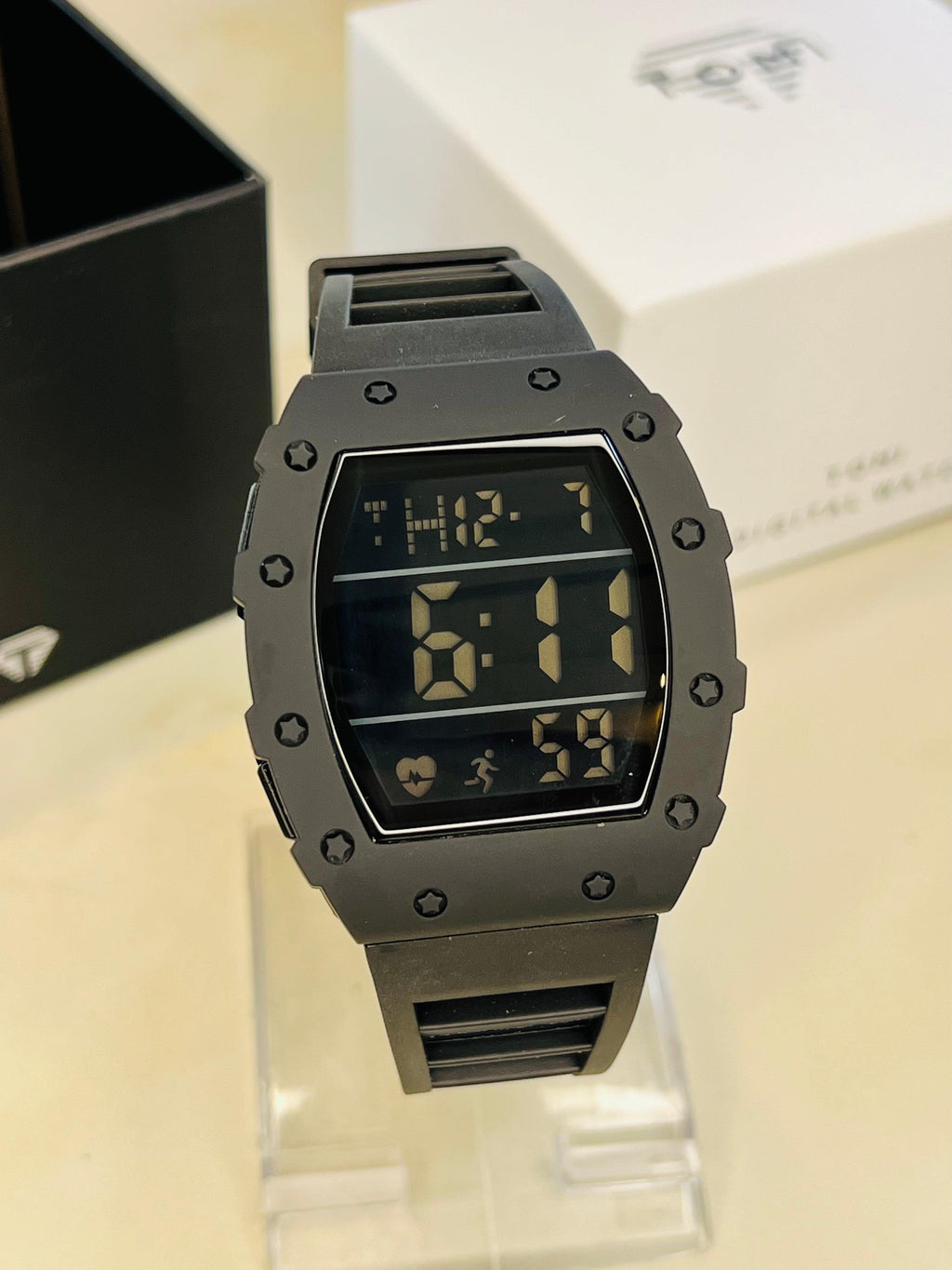 TOMI T-230 Digital Sports Watch - Dark grey digital sports watch with a black strap displayed upright.