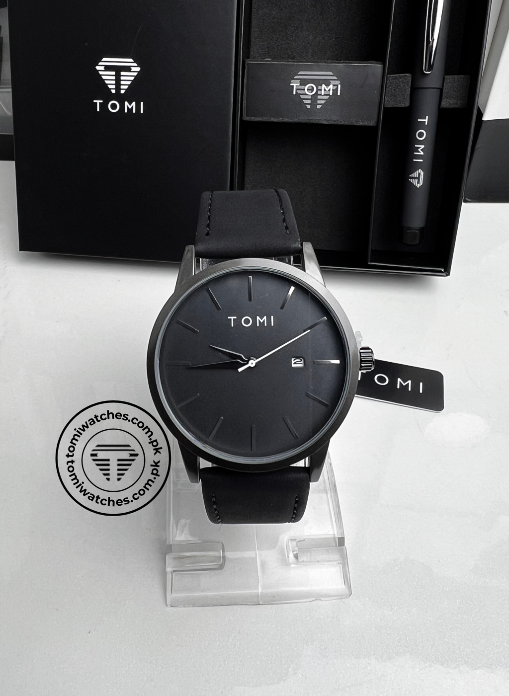 TOMI T-071 men's black leather strap date watch displayed with TOMI pen inside gift box