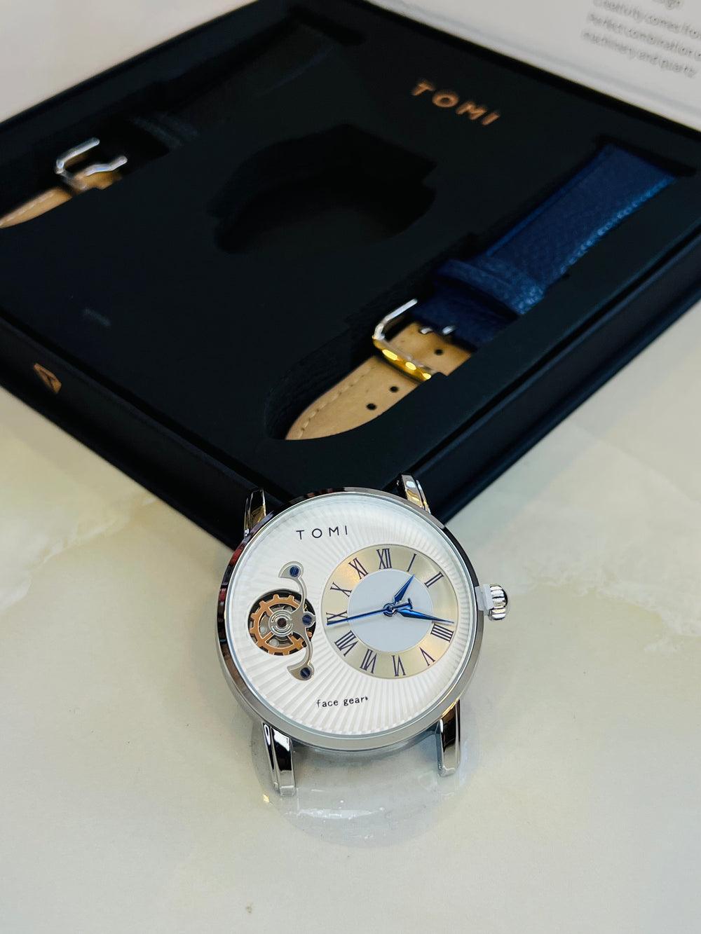 Tomi T-104 Dual Strap Pair Watch featuring a silver-tone case, blue-accented dial, and dark leather strap.