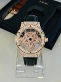 TOMI Rose Gold Face Gear watch close-up with brown leather strap and black strap
