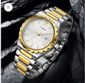 Tomi T-302 S3 Series Watch photographed close up with its white dial and two-tone metal bracelet.