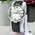 TOMI T-075 classic silver case wristwatch with a white dial and black strap on a display stand