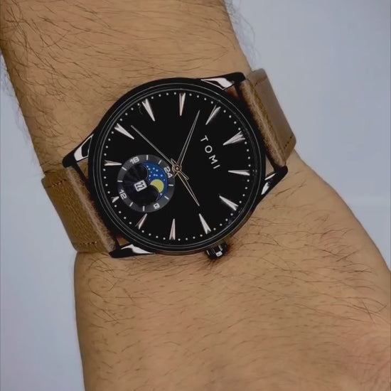 TOMI T-024 leather strap watch with black dial on wrist close-up