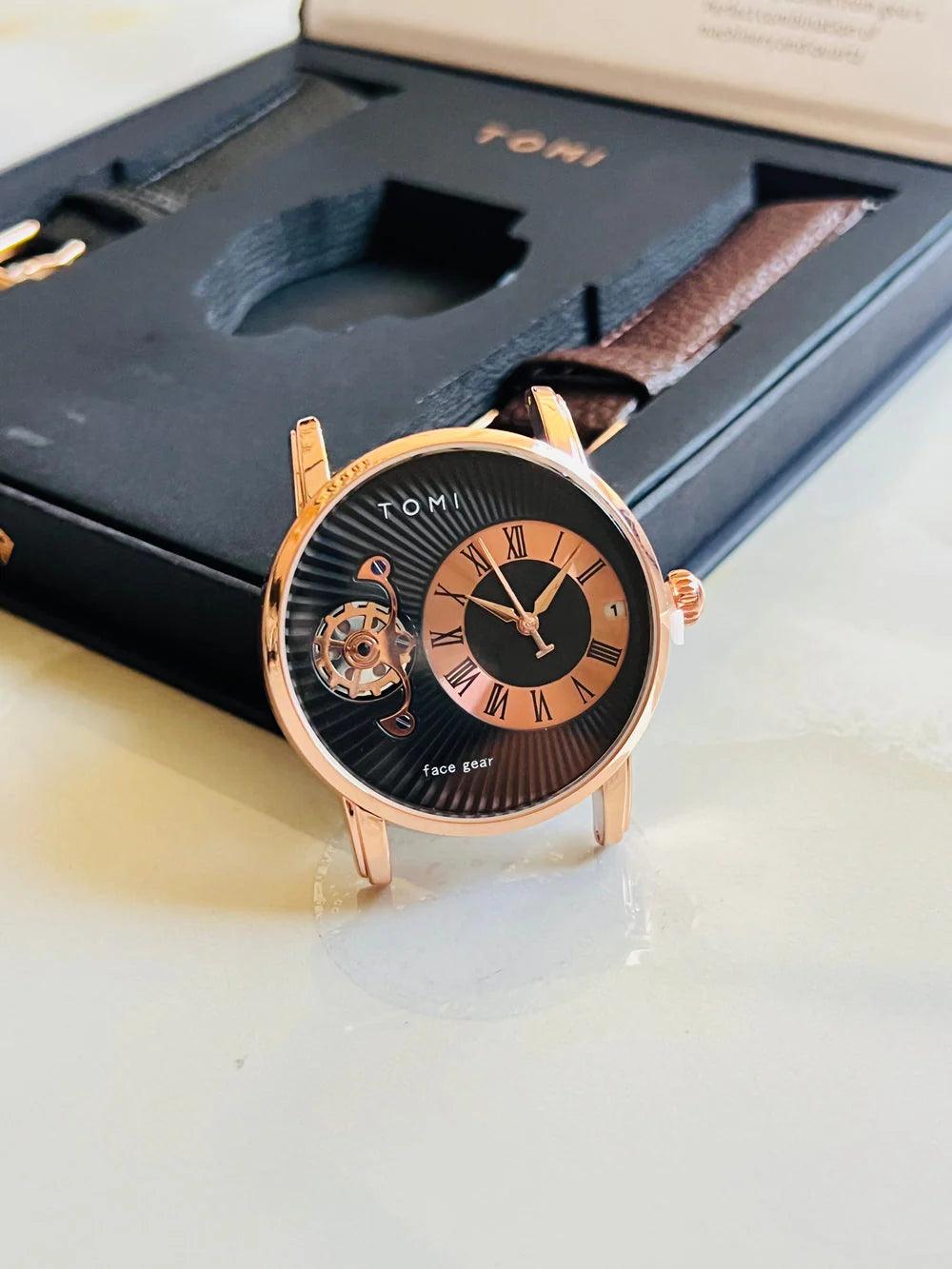 Tomi T-104 Dual Strap Pair Watch shown in close-up with a brown leather strap and rose gold-tone case.