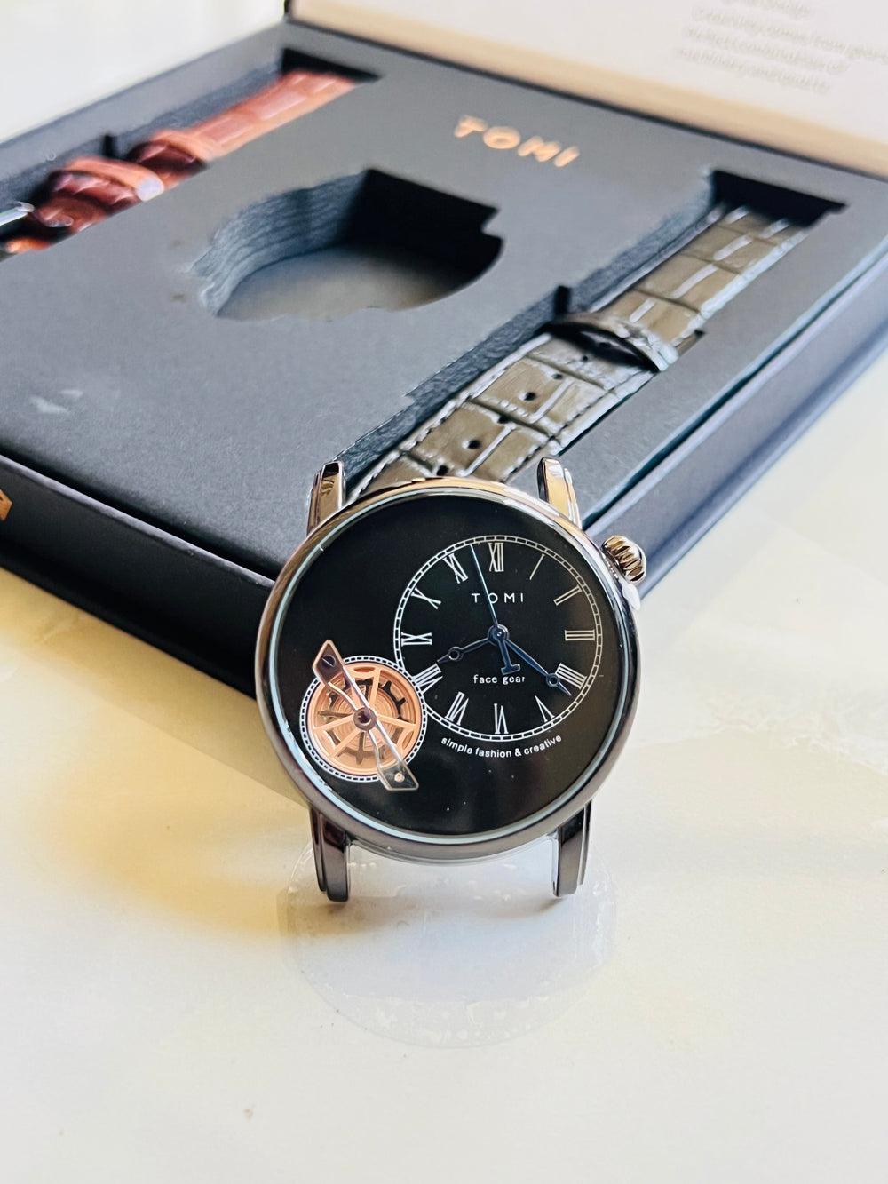 TOMI T-103 Dual Strap Face Gear  Watch with a black dial, silver case, and exposed gold gear detail