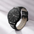 TOMI T-045 Quartz Wrist Watch For Men - Black dial watch with a black leather strap displayed on a white background.